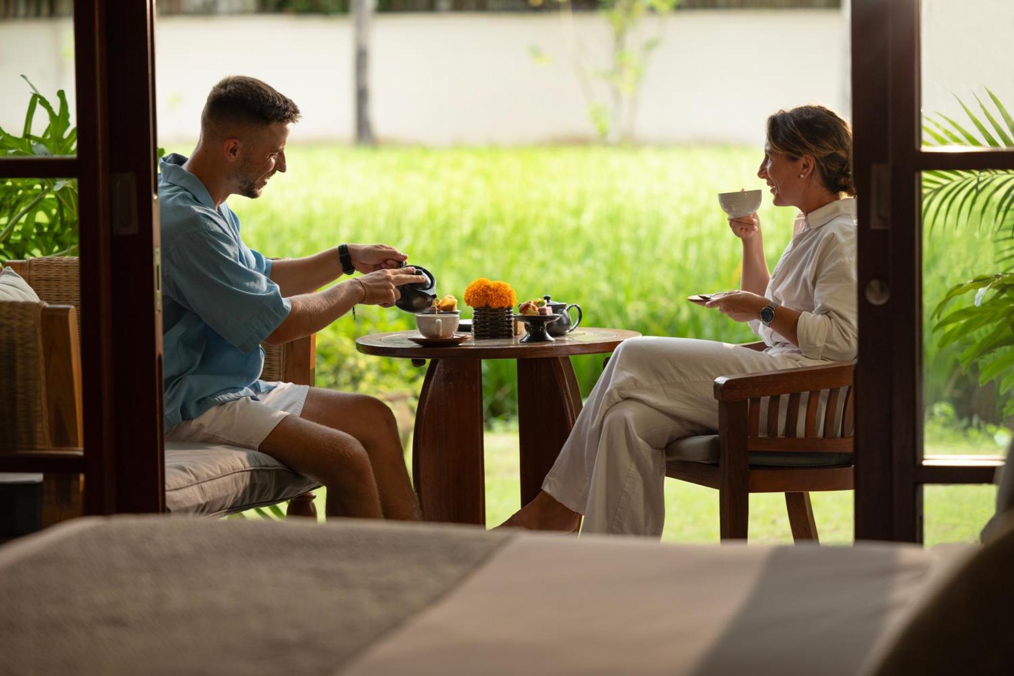 Hotel Adiwana Bisma Ubud Esterno foto A couple drinking tea